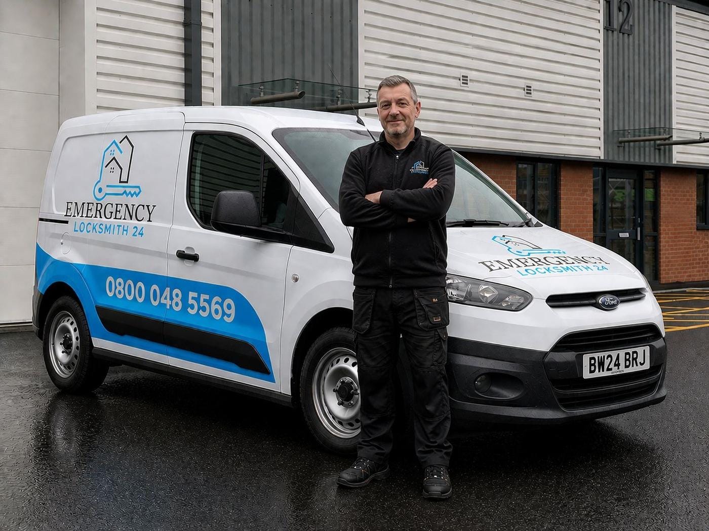 Emergency Locksmith 24 technician standing beside the branded service van — phone number 0800 048 5569 and company logo clearly visible — ready to dispatch across Brighton.